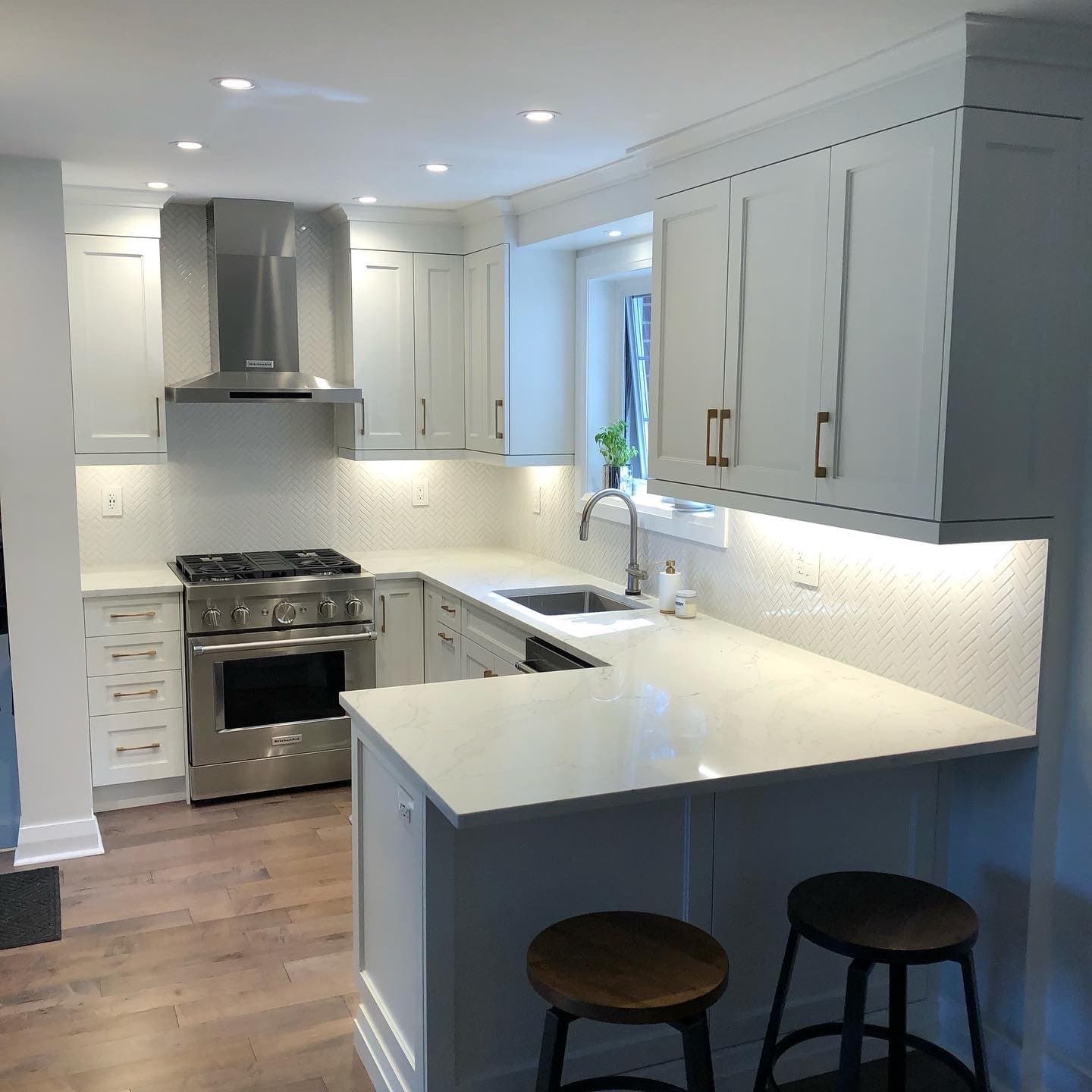 Contemporary kitchen remodel featuring custom countertops and lighting
